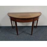 A 19th century mahogany demi lune table