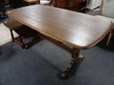 An Ercol elm dining table with under stretcher