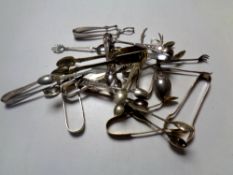 A collection of silver plated sugar tongs,