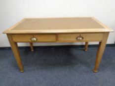 An Edwardian oak writing table fitted two drawers