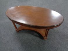 A reproduction mahogany oval coffee table