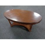 A reproduction mahogany oval coffee table