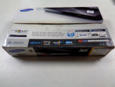 A Samsung 3D Blu-ray player in box with remote