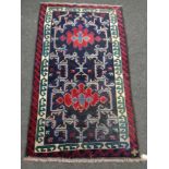 A Baluchi rug 140cm by 81cm