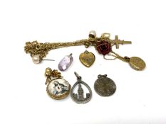 A small quantity of costume pendants, heart locket, crucifix,