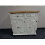 A contemporary side cabinet with pine effect top,