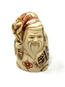 A carved Chinese bone netsuke - Village elder carrying a sack