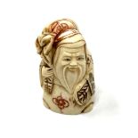 A carved Chinese bone netsuke - Village elder carrying a sack