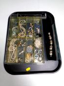 A tray of silver and costume jewellery including silver crucifix, simulated pearls,