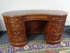 A Chapman's reproduction mahogany kidney shaped writing desk fitted nine drawers