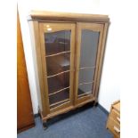 A continental glazed mahogany double door bookcase