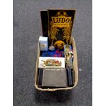 A box containing two folding vintage board games, Ludo and Snakes & Ladders,