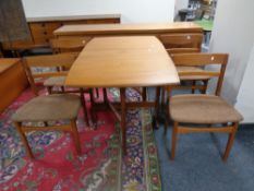 A 20th century teak drop leaf dining table and a set of four matching chairs