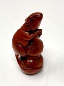 A carved Chinese hardwood netsuke - Rat climbing a post