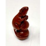 A carved Chinese hardwood netsuke - Rat climbing a post