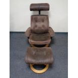 A relaxer armchair with matching footstool in brown suede upholstery on pine effect base