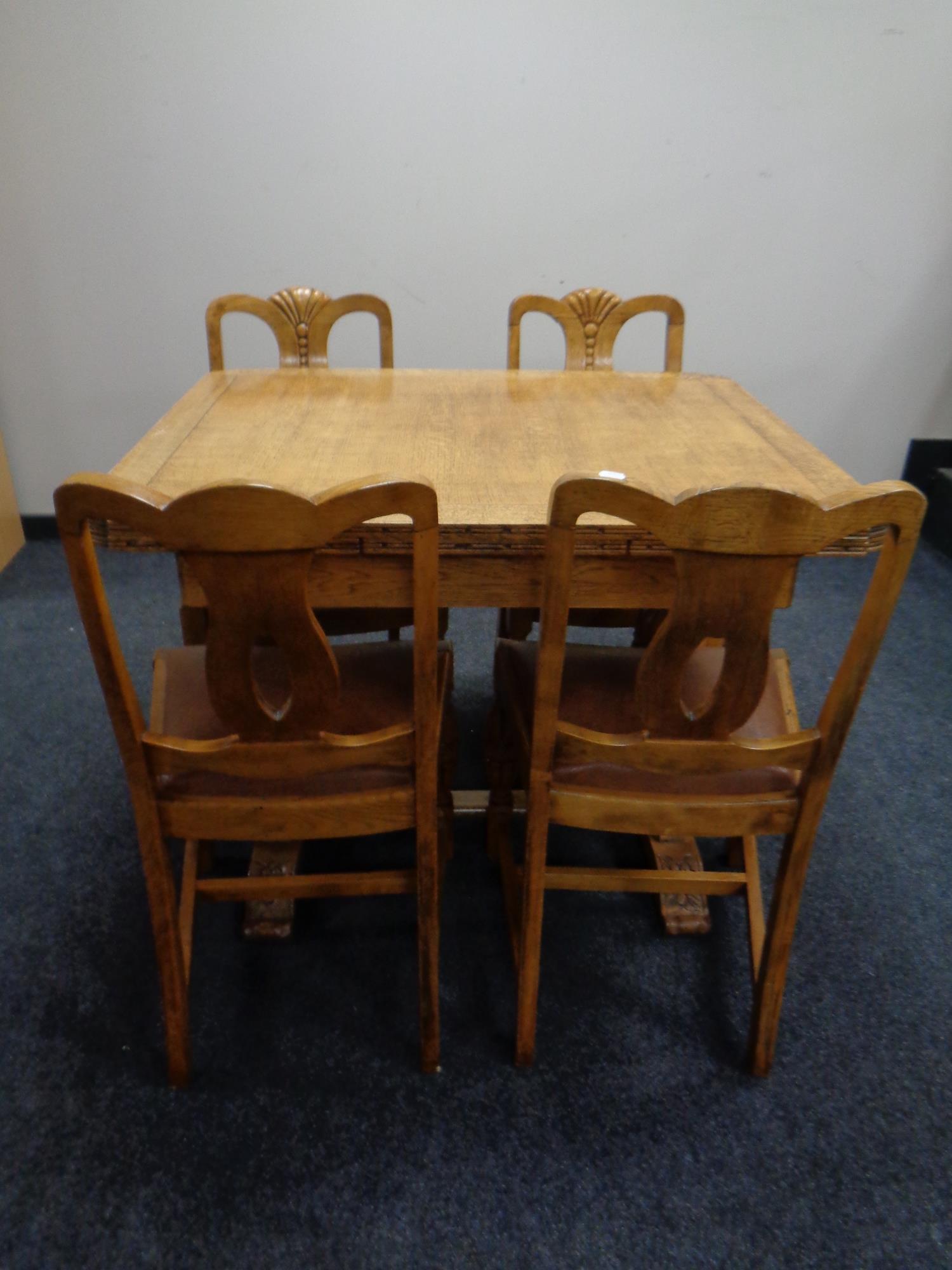 A 1930s heavily carved oak buffet sideboard together with matching pull out dining table and set of - Image 2 of 3