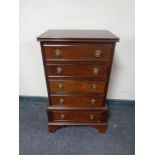 A miniature chest of five drawers