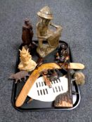 A tray containing wooden items including boomerang, African shield,