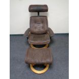 A relaxer armchair with matching footstool in brown suede upholstery on pine effect base