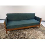 A continental beech framed settee in button green upholstery