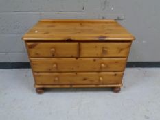 A contemporary pine four drawer low chest