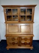 A contemporary hardwood secretaire bookcase fitted cupboards beneath