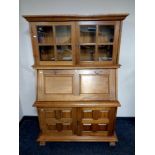 A contemporary hardwood secretaire bookcase fitted cupboards beneath