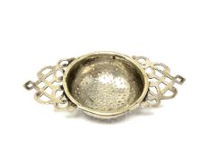 A silver plated strainer