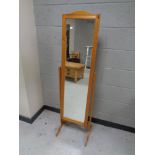 A contemporary pine cheval mirror