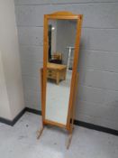 A contemporary pine cheval mirror