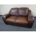 A brown leather two seater settee