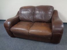 A brown leather two seater settee