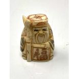 A carved Chinese bone netsuke - village elder with scroll and staff