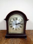 An Edwardian bracket clock with silver dial (electric)
