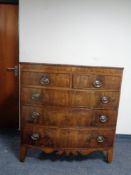 A regency inlaid mahogany bow fronted five drawer chest