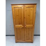 A contemporary pine double door wardrobe