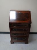 A reproduction inlaid mahogany lady's bureau