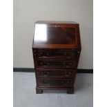 A reproduction inlaid mahogany lady's bureau