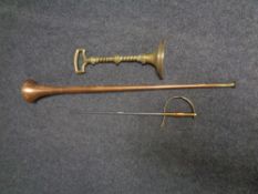 A brass door stop together with a copper horn and a fire poker in the form of a sword