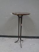 A circular marble topped tripod table