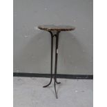 A circular marble topped tripod table