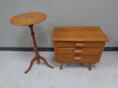 A 20th century teak three drawer chest together with a tripod table