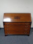 A 19th century mahogany and satinwood banded bureau fitted four drawers beneath