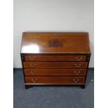 A 19th century mahogany and satinwood banded bureau fitted four drawers beneath