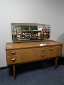 A mid 20th century teak mirror back dressing table