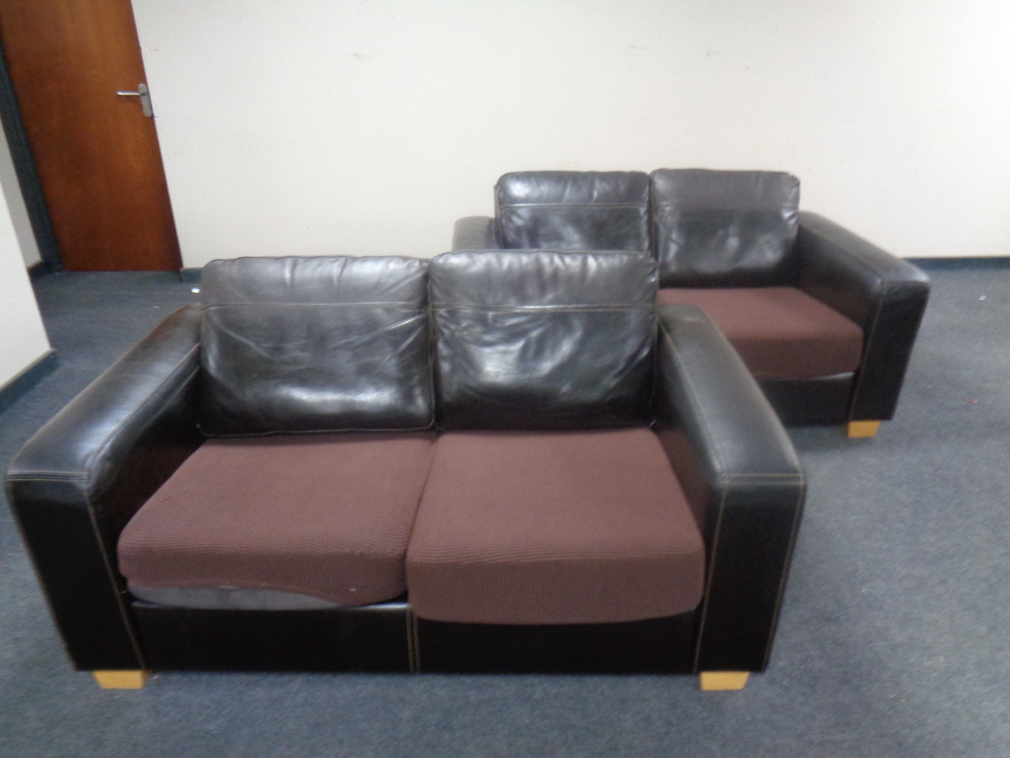 A pair of contemporary brown leather two seater settees