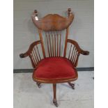 A spindle back armchair on castors