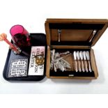 A tray containing canteen of Flex-Fit cutlery, cast iron plaques,