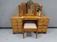 A contemporary pine dressing table fitted eight drawers with mirror back and stool